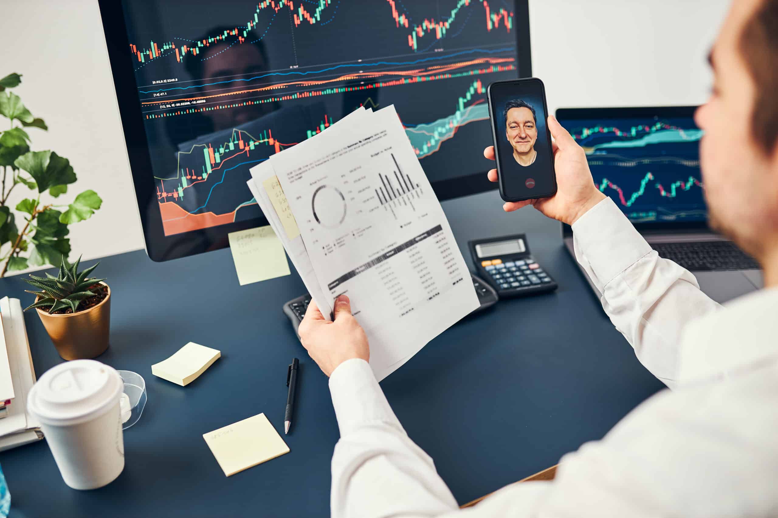 businessman trading stocks online. stock investor discussing numbers at graphs while video conversation with his colleague. business team planning and analyzing stock market graphs. man working with stock chart data. business man investing stock using onl